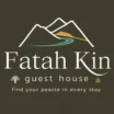 Fatah Kin Guest House logo featuring stylized white mountain peaks with a green and yellow river path, along with the text 'Fatah Kin guest house' and the slogan 'find your peace in every stay.' The design includes a small tree icon and a star symbol, all set against a dark background.